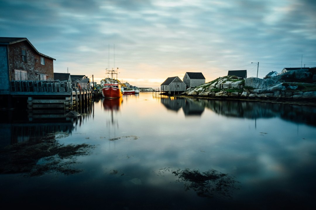Misty morning harbor in a small Danish fishing village with colorful wooden boats
